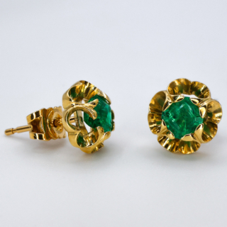 Fresh Springtime 18ct Emerald Flowerhead Stud Earrings.The emeralds are natural and set in buttery 18ct yellow gold,the mount surrounds the 'emerald bud' with scrolling claw setting.They are secured on the ear by a post and butterfly.Easy and comfortable to wear.Contact us if you would like further information about these earring