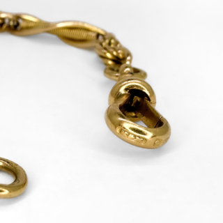 Unusual 18ct Antique Albert Fancy Link Bracelet.7.5 inches long.The chain has spacing knots between the longer twisting links which have long gold 'springs' inside.The securing mechanism is a hallmarked dog clip with a bolt ring on the other side.The dog clip and long links have the makers mark and 18ct mark.