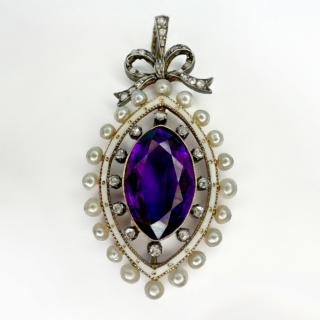 Exquisite Antique Marquise Amethyst Pearl & Diamond Pendant.A fabulous Edwardian pendant with a central oval rich colour amethyst surrounded by white enamel which has central gold decoration.The outer aspect of the pendant has rose cut diamonds and natural pearls surrounding.There is a rose diamond set bale and bow of which the pendant hangs.The chain is not included but can be sold separately.Please contact us if you would like further information on this stunning antique pendant.