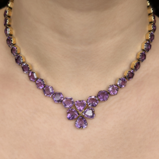 Beautiful Antique Victorian Amethyst Necklace. The hexagonal amethysts are collet claw set and linked, the necklace is flexible measuring 16 inches in total. Each amethyst measures 0.4 inches leading to a clover shaped amethyst heart made up of collet set heart shaped amethysts. The necklace has 40 rich purple amethysts in total including the securing clasp. There is a catch at the back of the necklace has a hexagonal collet set amethyst with a securing gold snap plate which has a 1.4 inch gold chain either side. A stunning antique and unique necklace. Please contact us if you would like to know more about this necklace or visit us at Saddingtons Jewellery, Mayfair.