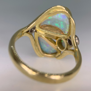 Fancy Asymmetric Water Opal and Diamond Ring in 18ct Yellow Gold, Hallmarked London, 1963. The unusual vintage custom made ring holds three vibrant water opals, two are of asymmetric shape, one circular. The opals are a mesmerising turquoise blue and purple with hints of green and yellow, we would even go as far as saying the colours are fluorescent. The split shoulders are decorated with two brilliant cut diamonds, of different cartage. The total head of the ring measures approximately 21.8 mm x 17 mm, The depth of the head 7 mm approximately. All the stones are bezel set in a half round polished shank. This ring is in immaculate condition, the opal will be professionally polished before any purchase. 