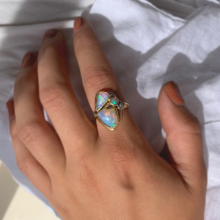 Fancy Asymmetric Water Opal and Diamond Ring in 18ct Yellow Gold, Hallmarked London, 1963. The unusual vintage custom made ring holds three vibrant water opals, two are of asymmetric shape, one circular. The opals are a mesmerising turquoise blue and purple with hints of green and yellow, we would even go as far as saying the colours are fluorescent. The split shoulders are decorated with two brilliant cut diamonds, of different cartage. The total head of the ring measures approximately 21.8 mm x 17 mm, The depth of the head 7 mm approximately. All the stones are bezel set in a half round polished shank. This ring is in immaculate condition, the opal will be professionally polished before any purchase. 