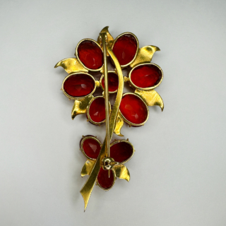 Stunning Vintage Fire Opal Flower Bloom Brooch Circa 1950's. Vibrant and magnificent brooch set with 10 juicy fire opals, 9 oval and 1 circular. The brooch measures 5.5cm long and 3cm wide. Set over 18ct yellow gold leaves and stem. The back has a pin and safety fastener. Contact us if you wish further information.