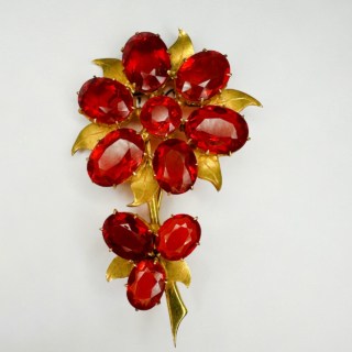Stunning Vintage Fire Opal Flower Bloom Brooch Circa 1950's. Vibrant and magnificent brooch set with 10 juicy fire opals, 9 oval and 1 circular. The brooch measures 5.5cm long and 3cm wide. Set over 18ct yellow gold leaves and stem. The back has a pin and safety fastener. Contact us if you wish further information.