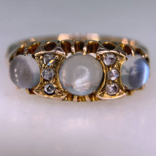 Stunning Edwardian Moonstone and Diamond Half Hoop in 18ct Rose Gold, Hallmarked Birmingham. This rare half hoop holds three cabochon Moonstone. The centre stone measures approximately 5 mm in diameter, the two side stones measure 3.8 mm in diameter, six rose cut diamonds with the diameter of 1.5 mm each separate the moonstones. All the stones are claw set in a decorative gallery 4 mm in depth, the shoulders run into a smooth polished half round shank, circa the Edwardian era. The ring is in excellent condition.