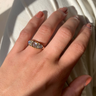 Stunning Edwardian Moonstone and Diamond Half Hoop in 18ct Rose Gold, Hallmarked Birmingham. This rare half hoop holds three cabochon Moonstone. The centre stone measures approximately 5 mm in diameter, the two side stones measure 3.8 mm in diameter, six rose cut diamonds with the diameter of 1.5 mm each separate the moonstones. All the stones are claw set in a decorative gallery 4 mm in depth, the shoulders run into a smooth polished half round shank, circa the Edwardian era. The ring is in excellent condition.