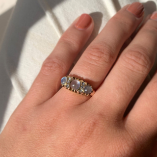 Stunning Edwardian Moonstone and Diamond Half Hoop in 18ct Rose Gold, Hallmarked Birmingham. This rare half hoop holds three cabochon Moonstone. The centre stone measures approximately 5 mm in diameter, the two side stones measure 3.8 mm in diameter, six rose cut diamonds with the diameter of 1.5 mm each separate the moonstones. All the stones are claw set in a decorative gallery 4 mm in depth, the shoulders run into a smooth polished half round shank, circa the Edwardian era. The ring is in excellent condition.