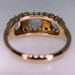 Stunning Edwardian Moonstone and Diamond Half Hoop in 18ct Rose Gold, Hallmarked Birmingham. This rare half hoop holds three cabochon Moonstone. The centre stone measures approximately 5 mm in diameter, the two side stones measure 3.8 mm in diameter, six rose cut diamonds with the diameter of 1.5 mm each separate the moonstones. All the stones are claw set in a decorative gallery 4 mm in depth, the shoulders run into a smooth polished half round shank, circa the Edwardian era. The ring is in excellent condition.