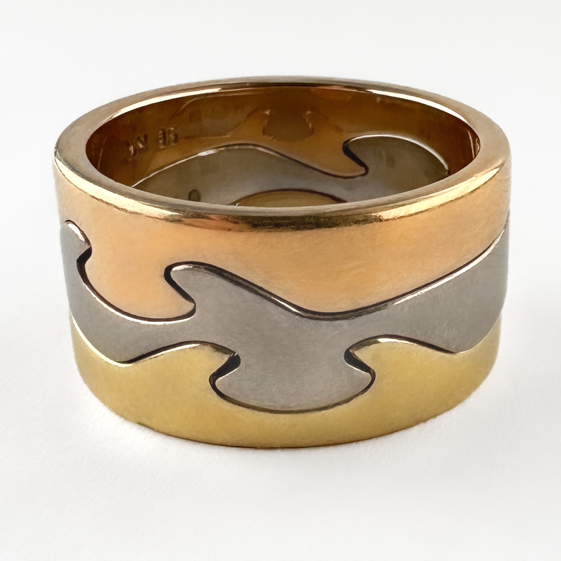 Georg Jensen Fusion 3 Ring Stack. This Iconic stack has 3 18ct gold tricolour bands that seamlessly interlock. The organic wave like bands 'fuse' together to create a contemporary and interesting design. These rings were designed by Nina Koppel who was commissioned by Georg Jensen. All 3 bands feature full Georg Jensen hallmarks including a Denmark stamp, N K stamp and 750 gold stamp. These yellow, rose and white gold rings can be worn together or separately. Please contact us if you would like to know more about this beautiful ring stack or visit us at Saddingtons Jewellery, Mayfair.