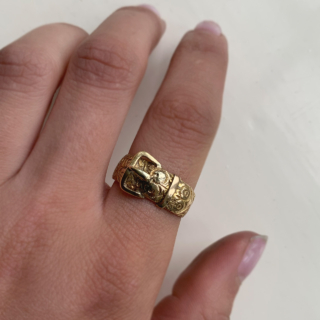 Stunning Rose Vine Chased Buckle Ring in 18ct Yellow Gold, Hallmarked Birmingham, 1887. The ring is decorated with roses and thorns, the buckle itself and the inner shank is polished, it is likely the roses signify the year of Queen Victorias Golden Jubilee. The buckle width is 11 mm and the band width measures 8 mm. The ring tapers towards the back, the back of the ring is slightly worn, with the rose detailing rubbed off, however overall an excellent antique ring in good condition. The date of this ring correlates to Queen Victorias Golden Jubilee.  