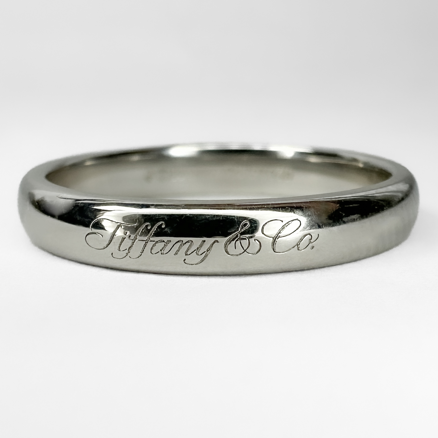 Tiffany & Co Platinum Wedding Band. This wedding ring is fully hallmarked with the modern Tiffany & Co marks both inside and on the outside. The 950 stamped platinum band weighs 4.7 grams. The band  is 'D' shape 1/2 round and is 0.3mm wide. Please contact us if you would like to know more about this ring or visit us at Saddingtons Jewellery, Mayfair.