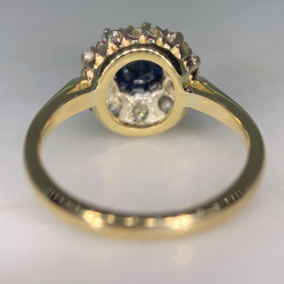 Stunning Circular Sapphire and Diamond Halo Cluster Ring in tested 18ct Yellow Gold. The ring has an unmarked smooth polished split shoulder shank. The basket and head diameter measures approximately 11.5 mm, with a depth of 6.5 mm. The central sapphire is a mesmerising deep blue and measures approximately 5.8 mm in diameter. The sapphire is encapsulated by 10 old cut diamonds, all stones are claw set. The ring is in immaculate condition.