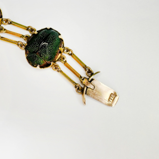 Rare and Beautiful Antique Victorian Scarab Beetle Bracelet Circa 1880. The scarabs are individually set in 15ct yellow gold and are claw set and are spaced by three row gold bars. bracelet consists of one row of individual set scarab beetles. The bracelet has a secure snap clasp, the beetles are all mounted in 15ct yellow gold.   A rare antique bracelet in excellent condition. The gold is marked, 15ct gold on snap plates. The bracelet measures approximately 17-17.5cm/7 inches long and 1.5cm/0.5cm wide. The bracelet measures approximately 24.4mm to 31.2mm wide (clasp).