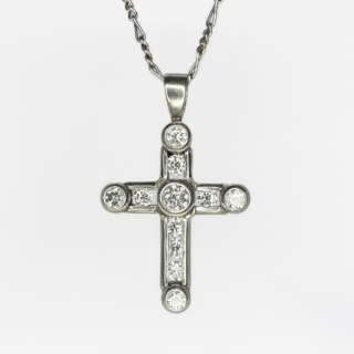Platinum And Diamond Set Cross Pendant. 10 bright and sparkling round brilliant cut diamonds in a rub over setting. The chain is not included, we have a selection of chains available to purchase. Please contact us if you would like to know more about this beautiful cross pendant or visit us at Saddingtons Jewellery, Mayfair.