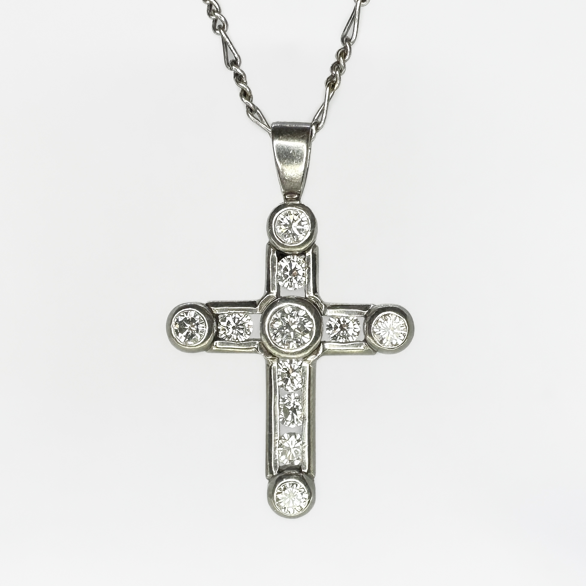 Platinum And Diamond Set Cross Pendant. 10 bright and sparkling round brilliant cut diamonds in a rub over setting. The chain is not included, we have a selection of chains available to purchase. Please contact us if you would like to know more about this beautiful cross pendant or visit us at Saddingtons Jewellery, Mayfair.