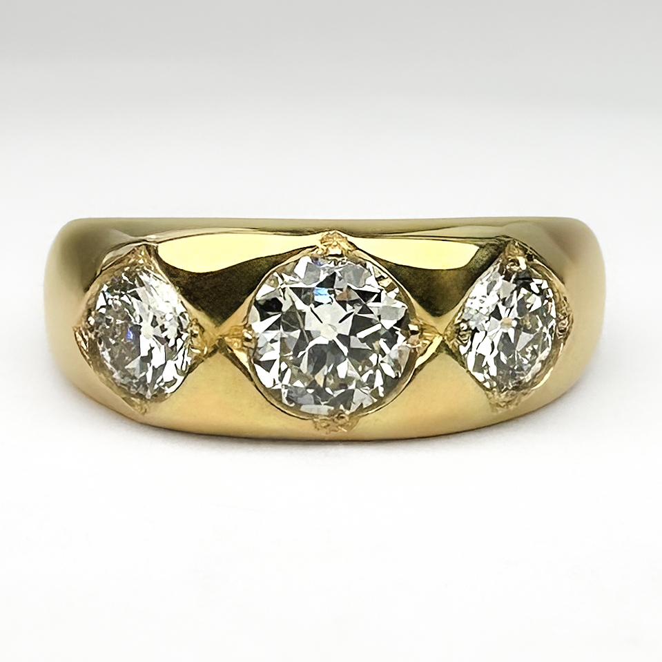 Edwardian Antique 3 Stone Diamond Gypsy Ring. The 3 diamonds are all grain set in 18ct yellow gold, with a 18ct stamp in the shank. Also in the shank is a marker mark of 'IB'. The gypsy ring weighs 7.9 grams and the total diamond weight is 1.40 cts, the centre diamond is 0.7cts. All the stones in this beautiful ring are Edwardian transitional brilliant cut. Please contact us if you would like more information about this gypsy ring or visit us at Saddingtons Jewellery, Mayfair. 
