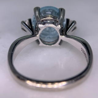 Exquisite Outsized Aquamarine and Diamond Trilogy Ring, in stamped 18ct White Gold. The centre aquamarine measures 3.8carats, enclosed by two diamonds. All the stones are claw set and measure 16 mm x 12 mm together, with a basket depth of 7 mm. The ring has a stylish flat-sided court shank, with a sort of square outer appearance. Excellent ring.