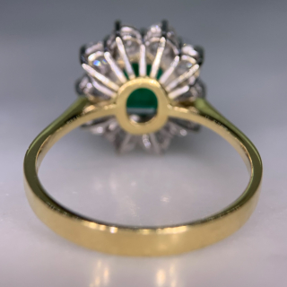 Outstanding Emerald and Diamond Rectangular Cluster Ring in 18ct Yellow Gold, Hallmarked London, 1990. The exquisite ring has a 1.4carat immaculate glowing emerald as a centre stone, surrounded by 1.02carats of brilliant cut, bright white diamonds (total diamond weight). All the stones are claw set in a platinum basket, with a reverse taper, raised flat band shank. The head of the ring measures approximately 14 mm x 12.5 mm. The ring is in absolutely immaculate condition.
