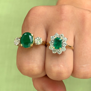 Outstanding Emerald and Diamond Rectangular Cluster Ring in 18ct Yellow Gold, Hallmarked London, 1990. The exquisite ring has a 1.4carat immaculate glowing emerald as a centre stone, surrounded by 1.02carats of brilliant cut, bright white diamonds (total diamond weight). All the stones are claw set in a platinum basket, with a reverse taper, raised flat band shank. The head of the ring measures approximately 14 mm x 12.5 mm. The ring is in absolutely immaculate condition.