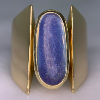 Unusual Brutalist Geometric Solitaire Moonstone Ring, stamped 750 (18ct) Yellow Gold. The exquisite ring has a 16 mm x 7 mm statement oval moonstone. The up-finger design of the ring shows an oval moonstone, bezel set, in yellow gold, with two geometric wide shoulders that taper to the back of the shank. The head measures approximately 21 mm x 11 mm, and tapers to 5 mm at the back of the ring. The ring is in absolutely immaculate condition and is a clear statement piece, great worn alone or in addition to other up-finger rings. 