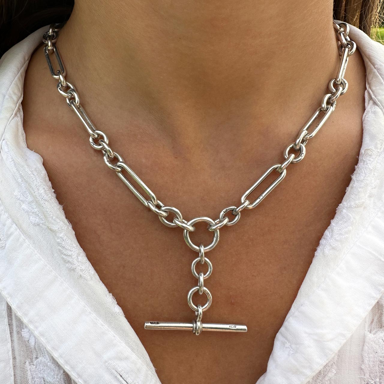 Striking and Rare Chunky Trombone Link Albert Neckchain in Hallmarked Birmingham 1927. The trombone links 0.7 inches/2 cm. The full chain measures 17 inches x 43cm with a dog clip catch. The front central large silver link drops to the T-Bar 1.5 inches /3cm. A stunning Albert Chain.