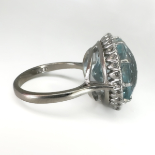 Statement Large Aquamarine Diamond Circular Cluster Ring.The central faceted 13.3ct  Aquamarine has a beautiful sea blue green hue and is surrounded by bright brilliant cut diamonds.A stones are natural and claw set in a 18ct white gold marked in the shank.The head of the ring measures 1.8cm diameter with a depth of 0.8mm off the finger.The ring can be resized,please contact us if you would like more information on this ring.