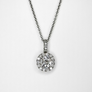Stunning 0.82ct Diamond Halo Pendant. The central natural diamond is an Edwardian cut diamond,Colour H-I,/clarity SI1.The central diamonds has a halo of bright diamonds with a diamond set bale.The diamonds are set in platinum with a platinum chain (18 inches). The pendant length is 3/4 inch drop from the top of the bale to the bottom of the pendant.Please contact us if you would like to know more about this stunning diamond halo pendant and chain.
