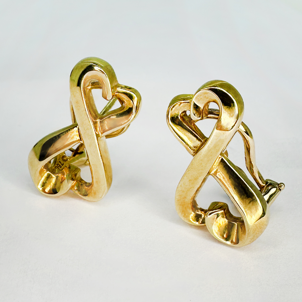 Authentic Tiffany&Co Gold Double Heart Love Earrings signed Paloma Picasso with T&Co 750 on the back of each earring. 2cm length by 1.2cm wide. The earrings have a stud pin securing with a D clip. Please contact us if you have any questions. The earrings are in excellent condition and have their Tiffany & Co pouch and box.