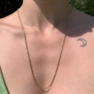 Beautifully classic 3mm Figaro 24" Chain in 9ct Yellow Gold, Hallmarked Italy, import mark Birmingham, 1985. The chain has a width of 3 mm, a length of 24" and is joined by a spring ring clasp. Lying elegantly flush to the skin, typical of a Figaro chain.