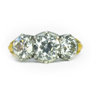 Stunning Antique 3 Stone Trilogy Diamond Ring 2.65ct in Total.This Victorian trilogy diamond ring has a central 1ct diamond weight, with the 2 outer diamonds weighing 1.65cts,the total weight of diamonds being 2.65cts.The diamond clarity of all 3 diamonds VS2,Colour G-H.The diamonds are. Victorian Transi.tions Brilliant Cut.The shank is 18ct yellow gold carved reeded,the diamonds are set in silver which is typical of Victorian ring