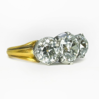 Stunning Antique 3 Stone Trilogy Diamond Ring 2.65ct in Total.This Victorian trilogy diamond ring has a central 1ct diamond weight, with the 2 outer diamonds weighing 1.65cts,the total weight of diamonds being 2.65cts.The diamond clarity of all 3 diamonds VS2,Colour G-H.The diamonds are. Victorian Transitions Brilliant Cut.The shank is 18ct yellow gold carved reeded,the diamonds are set in silver which is typical of Victorian rings.