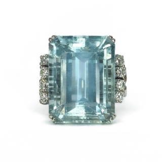 A Statement 21ct Aquamarine & Diamond Cocktail Ring.A fantastic vintage 1970's large aquamarine set with 4 beautiful full cut diamonds each side highlighting the central stone.The shank is polished 18ct white gold 9 marked inside the shank.The central aquamarine and diamonds are claw set.Typical of the era,the head of the ring sits just under 1cm from the finger,the head of the ring measures 1.8cm length x 1.8 width which includes the diamond rows on the side.The ring has a wide gold band 0.5cm wide.A beautiful statement on the finger,this ring can be resized.Please contact us if you would like to know more about this ring.
