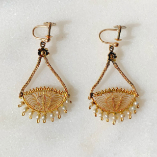 Incredible Pearl and Filigree Chandelier Earrings, in stamped 9ct Yellow Gold. Each earring holds 9 natural pearls, below an intricate filigree design. The design measures 25 mm in width and hangs beautifully by two foxtail chains that meet at a daisy design flower. The total earring design measures 43 mm x 25 mm. The earrings have a screw back fitting for non pierced ears, however can be worn by both pierced and non-pierced.