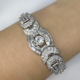 Stunning 1940's 15ct Diamond Bracelet. A very high quality 15ct total weight of diamond bracelet, diamonds set throughout. The bracelet measures 6.75 inches/17.14cm x  0.78 inches/2cm width at the widest point on the front of the bracelet. The central claw set brilliant cut diamond weights 1.5cts with 4 more smaller brilliant cut diamonds. Rub over baguette diamonds surround the central diamond. There are graine set brilliant cut diamonds covering throughout the circles and link style bracelet, the securing clasp is a snap plate with a further side clasp to secure further. A beautifully made bracelet mounted in platinum. Colour G-H, Clarity VS. Please contact us if you would like more information on this high quality and beautiful bracelet or visit us at Saddingtons Jewellery, Mayfair.