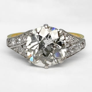 A brilliant example of an Art Deco 2.17ct Solitaire Diamond Ring. The central beautifully cut transitional cut diamond weighs 2.17 diamond carat weight. The diamond is claw set in platinum with graine set transitional cut diamonds in the shoulders. Colour H-I, Clarity VS2. All gems are set in platinum with an 18ct yellow gold ring shank. A beautiful ring. This ring can be resized, please contact us if you would like to know more about this ring or visit us at Saddingtons Jewellery, Mayfair.