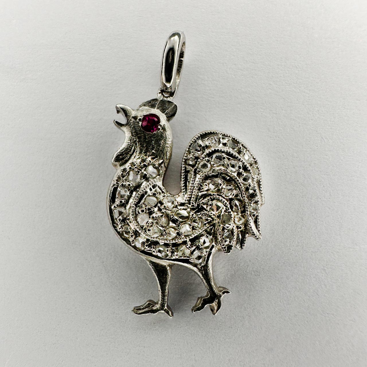 Edwardian Cockrell Stick Pin Pendant set with Rose Diamonds and Ruby Eye.The cockerell is in platinum. Originally the beautiful cockerell was a stickpin which were worn by gents in the Victorian and Edwardian period, now converted into a superb pendant. The cockerell stands 2.2cm including the bale, 1.2cm wide.
