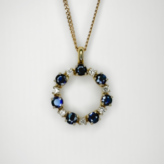 Exquisite Vintage Circular Diamond Sapphire Pendant. Beautiful bright brilliant cut diamonds alternating with midnight blue sapphires around the circle.The gems are set in 18ct yellow gold and are all claw set.there is an assay mark to the back of the pendant mount. The pendant measures 1.0 inch from the top of the bale to the bottom of the pendant. The total diameter from edge to edge of the pendant is 3/4 inch. The pendant is sold on its own but we can provide a chain at extra cost if required. Please contact us if you would like to know more about this beautiful pendant.
