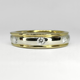 Two Tone Gold Diamond Set Wedding Band Ring.Pave set natural bright brilliant cut diamonds are spaced evenly around the band.The diamonds are set in the central band which is in 18ct white gold with the slightly raised channels of 18ct yellow gold on each side of the white gold central band. On the inside of the ring shank is the makers mark with the gold mark 750 and 18ct.Please contact us if you would like to know more about this beautiful ring.