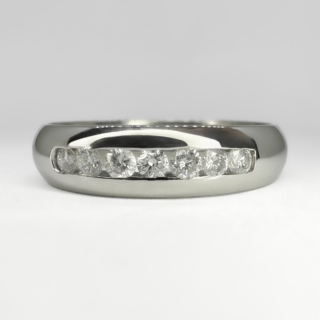 Vintage Platinum Band Ring Diamond Set. The platinum band ring has a London hallmark 2001.Bright polished finished with 7 bright channel set diamonds to the front of the of the band. The diamond line measures 1.5cm. This ring can be resized. Please contact us if you would like to know more about this ring.