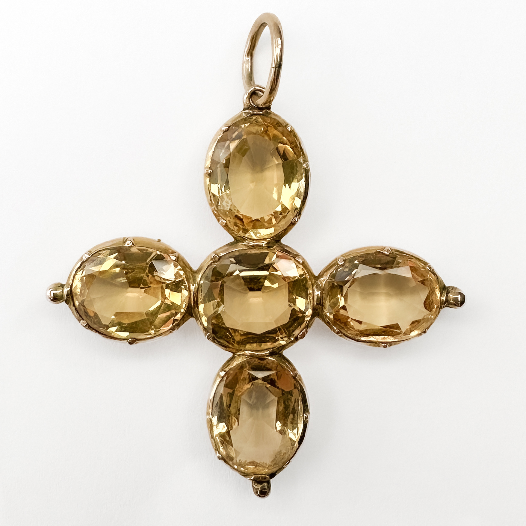 Rare Antique Topaz Cross Pendant. Circa 1880, this 5 stone natural topaz cross is set in 15ct yellow gold. The stones are claw set in the gold mount with a large bale at the top. At each there is a decorative gold ball. The Topaz stones are a lovely yellow peach tone. The chain is not included, a wide range of chains are available upon request. Please contact us if you would like to know more about this beautiful antique pendant or visit us at Saddingtons Jewellery, Mayfair.