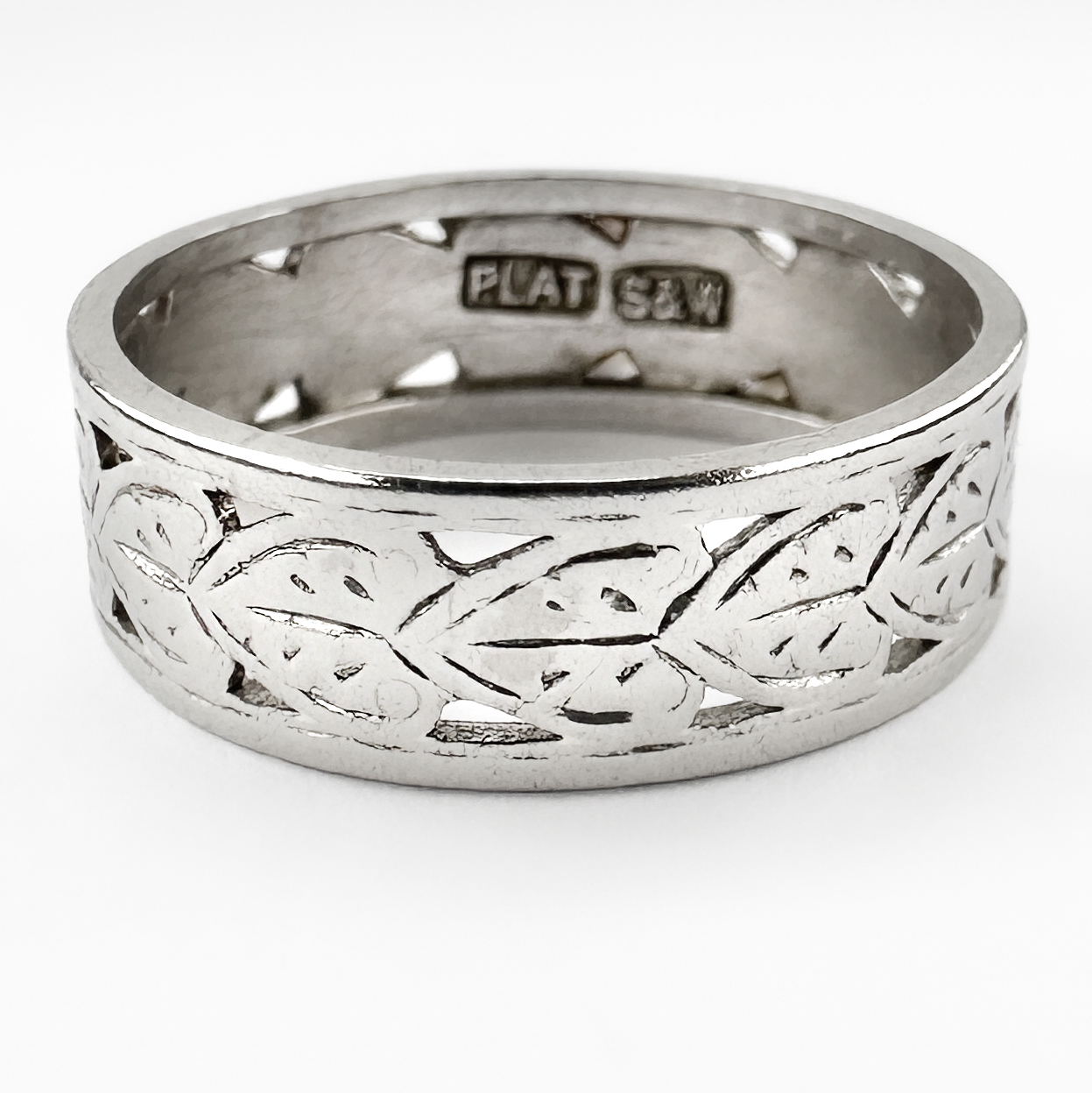 Art Deco Platinum Pierced Band. Crafted in platinum, the ring features an elegant continuous openwork design with finely pierced geometric and stylised foliate motifs characteristic of the Art Deco period. The delicate patterning gives the band a light architectural quality while retaining the durability. Inside the band is a platinum stamp and an S&W mark. Its refined decorative detailing make it ideal as a wedding band, stacking ring or understated everyday antique piece. The ring weighs 3.3g. Please contact us if you would like to know more about this sweet ring or visit us at Saddingtons Jewellery, Mayfair.