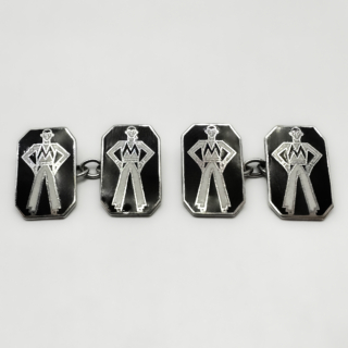 Antique And Unusual Art Deco Enamelled Jazz Man Cufflinks. Crisp black and white enamelled silver cufflinks measuring 11.5 x 8mm crafted in solid silver. Each cufflink features a wonderfully stylised Deco gentleman, angular lines with long legs and hands on hips. A humorous and elegant design of the popular 1930's Jazz Age. These original Art Deco cuff links are marked "Silver" on the back of each cufflink. There is a double panel plate with a chain link connector on each cufflink a typical construction of the era. They are presented in their original box. Please contact us if you would like to know more about these cuff links which are in excellent condition.