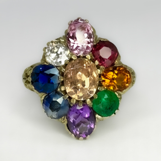 Beautiful And Rare Antique Multi Gem Cluster Ring. A striking and unusual marquise shaped multi stone ring set in 15ct yellow gold. A late Victorian ring circa 1890-1900 in original condition. The carved ring mount has scrolls with scrolls and leaves carved to the shoulders. The head of the multi gem cluster measures 15.5mm across, 18mm in length towards the finger. It is difficult to convey just how unusual and rare this ring is. We have never seen an example before, it is totally original. The gemstones set in the ring are all natural stones, in the centre is a yellow/orange sapphire and on the surrounding edge starting with a Victorian transitional cut diamond. Moving clockwise, a purple sapphire, ruby, orange sapphire, emerald, amethyst, light blue sapphire and finally a dark blue sapphire. Beautiful. Please contact us if you would like to know more about this ring.