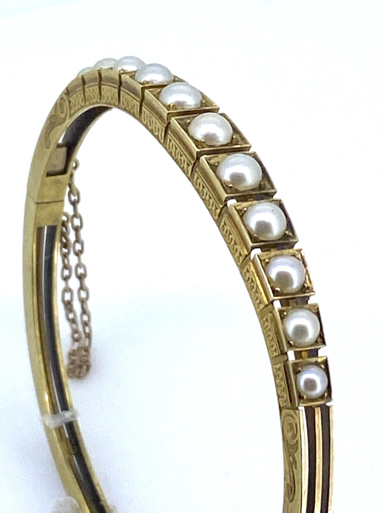 Victorian 15 carat Gold and Pearl Bangle.  Attractive Natural Pearl   Set Bangle with intricate chased decoration to the sides