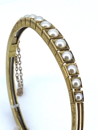 Victorian 15 carat Gold and Pearl Bangle.  Attractive Natural Pearl   Set Bangle with intricate chased decoration to the sides