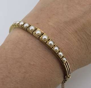 Victorian 15 carat Gold and Pearl Bangle.  Attractive Natural Pearl   Set Bangle with intricate chased decoration to the sides
