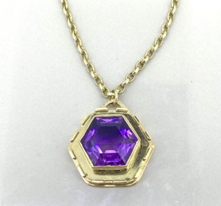 Amethyst pendant and chain. Hexagonal pendant in 9 carat gold mount with belcher chain