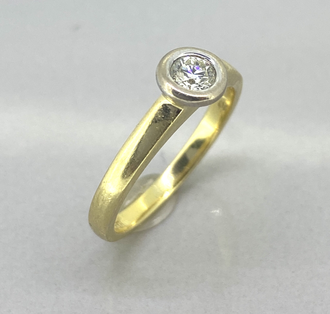 Vintage Diamond Ring has a rub over setting with the brilliant cut solitaire single stone diamond