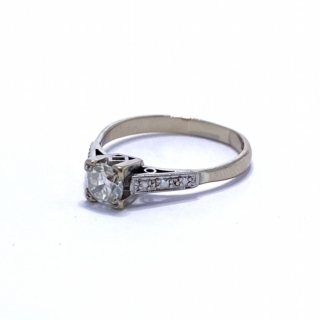 Brilliant Cut Solitaire Diamond, set in 18Ct white gold with intricate shoulder detail. The basket is square with geometric designs.