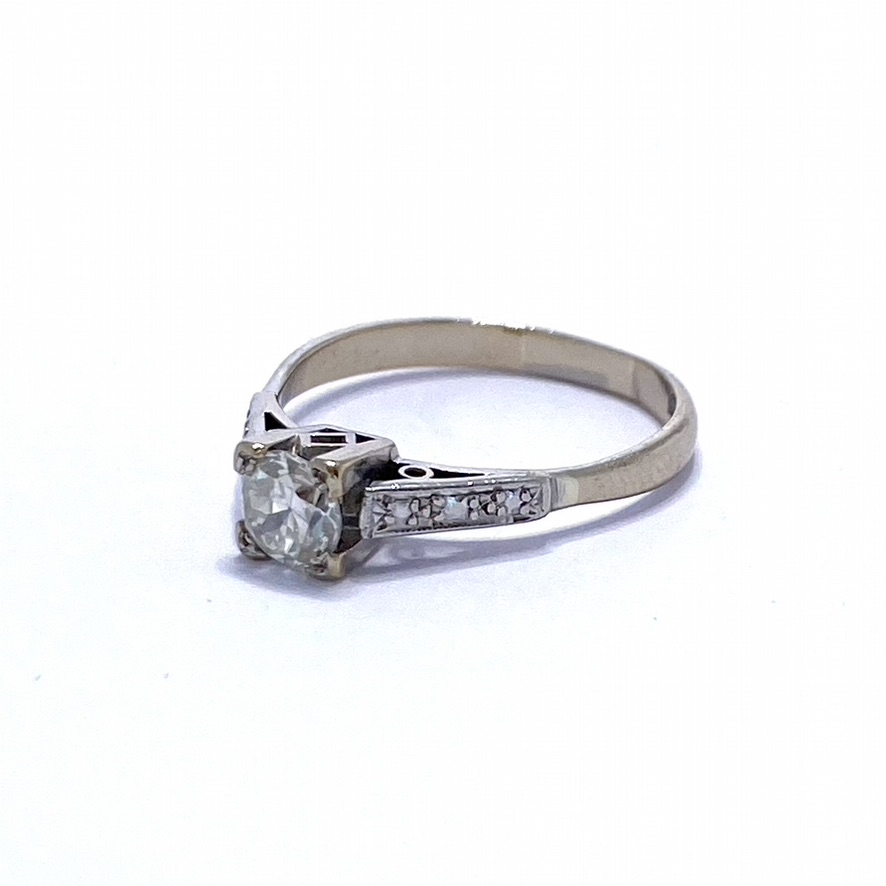 Brilliant Cut Solitaire Diamond, set in 18Ct white gold with intricate shoulder detail. The basket is square with geometric designs.